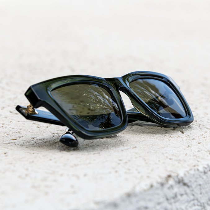 Dark square sunglasses on stone